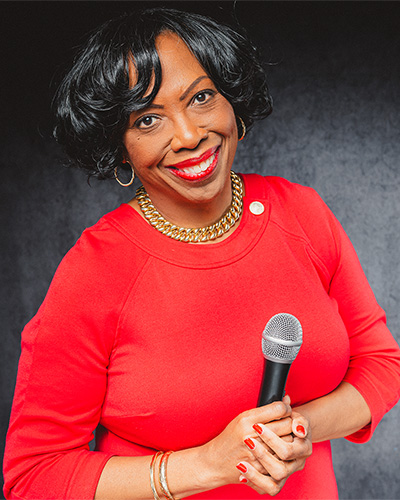 Joanne L. Smikle, PhD, holding a microphone